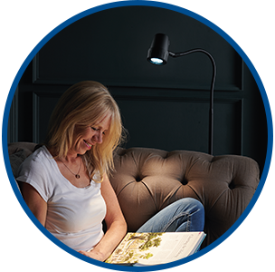 Woman reading with HD Essential floor light