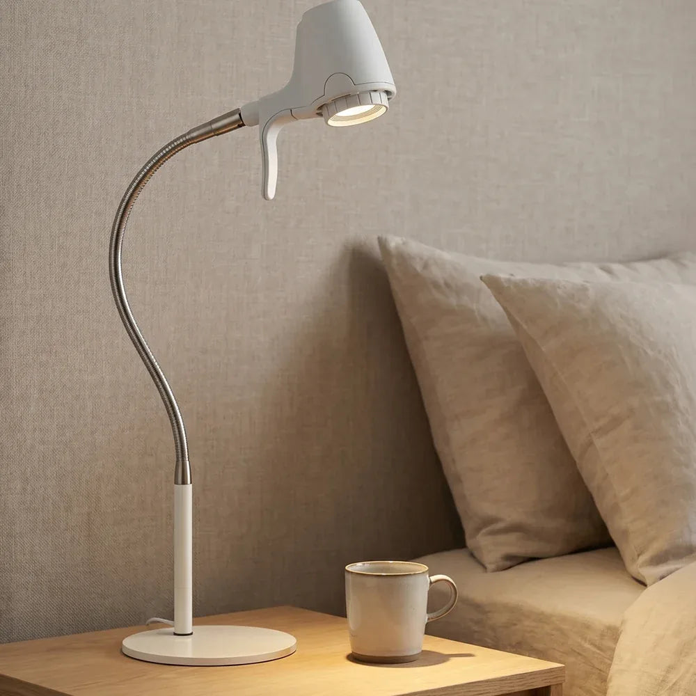 An HD Original Table Light in Heritage White on a bedside table beside the pillows