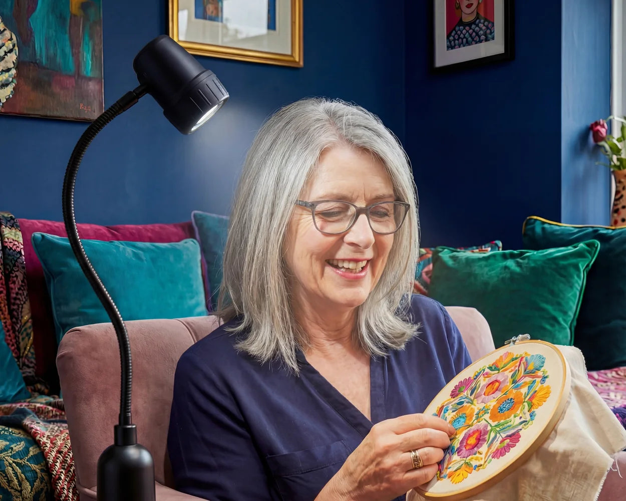 A woman seeing every colour in her embroidery by the light of an HD Essential Table Light