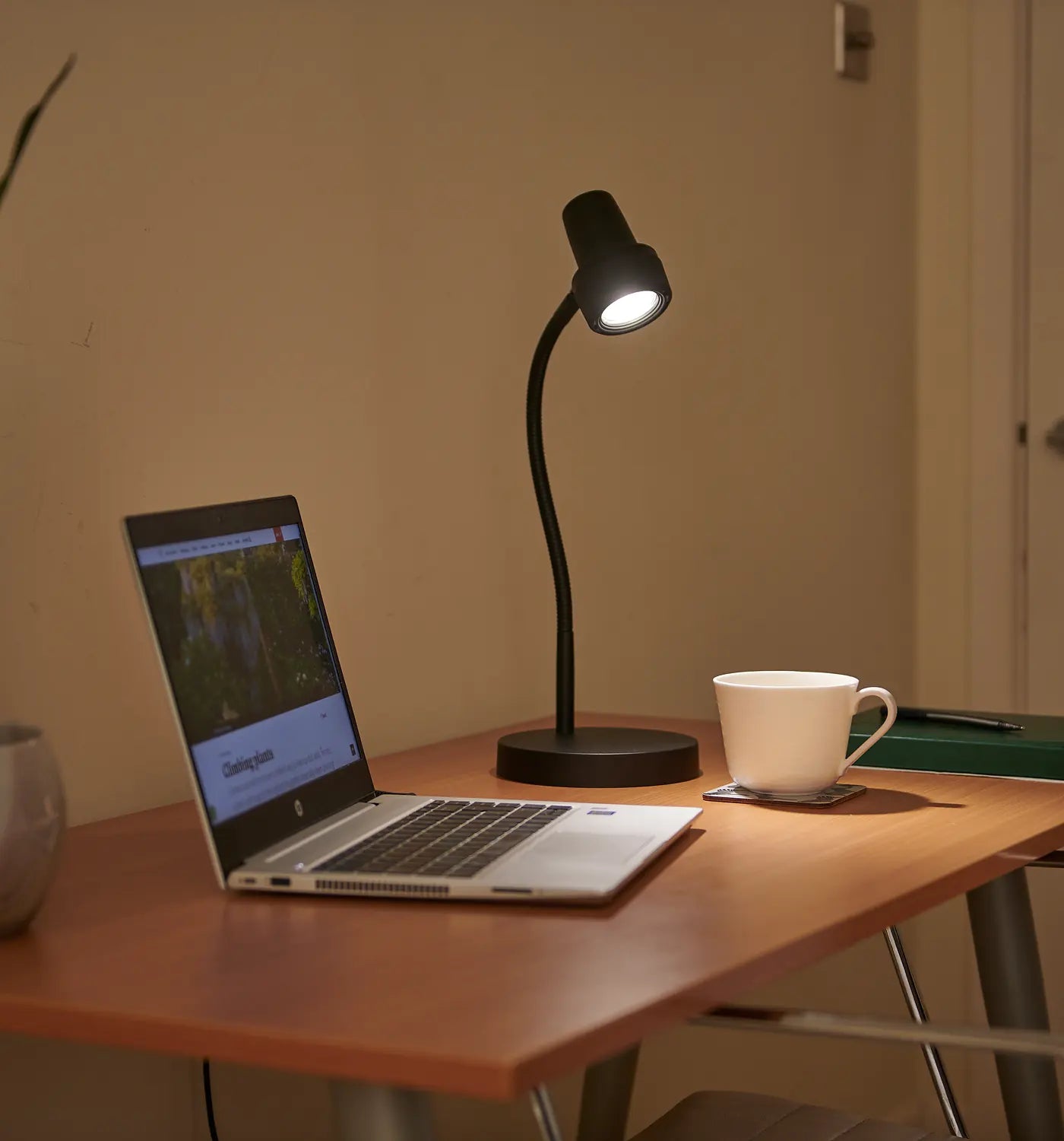 The HD Mini in Black lit on a study desk in the evening